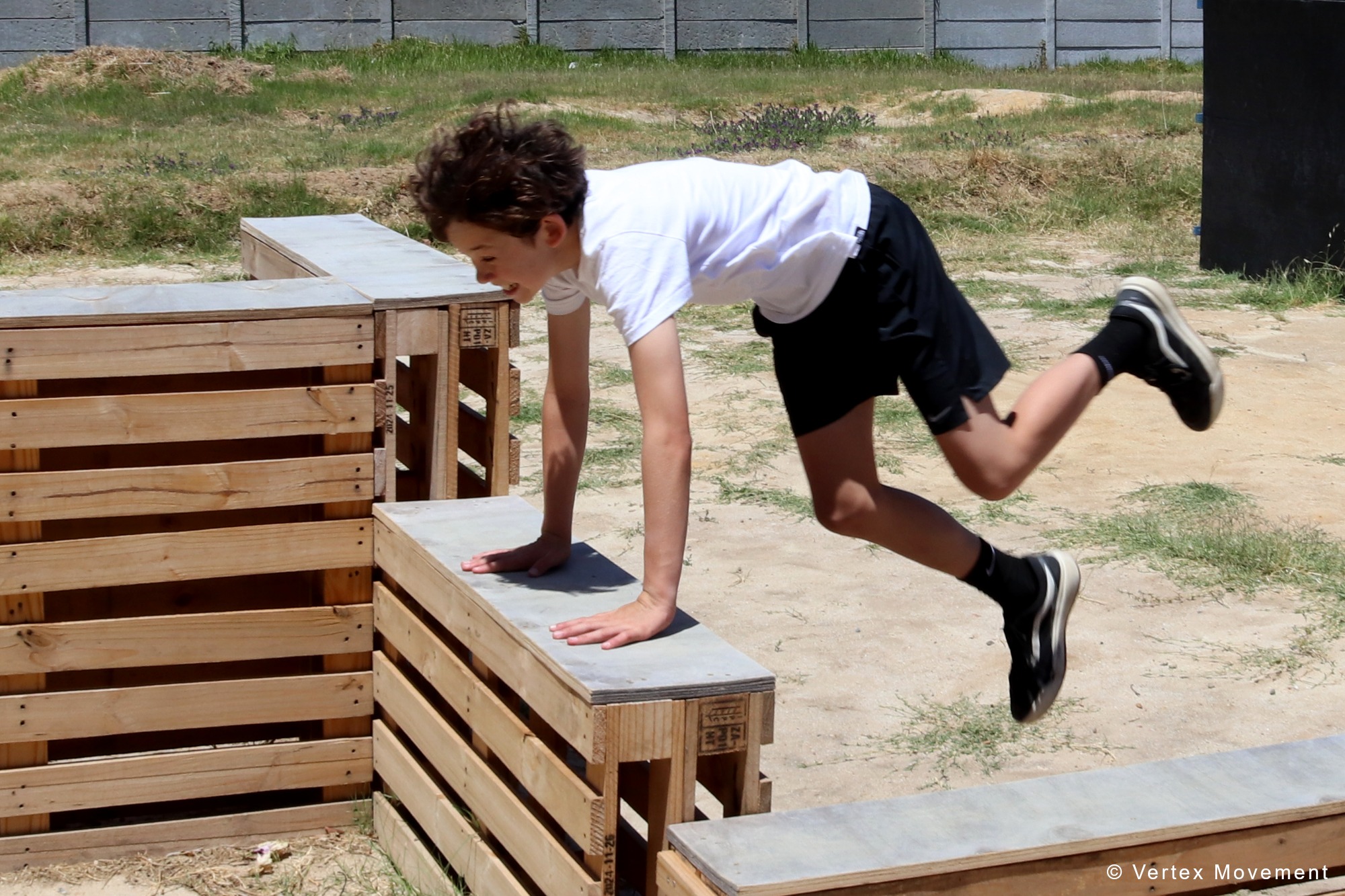 Young athlete practising a parkour vault at Vertex Movement